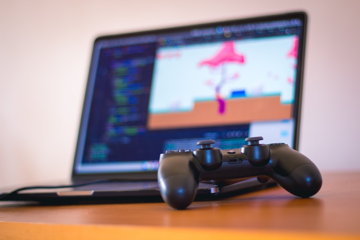 Game controller with laptop showing game development